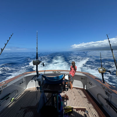 Looking out the back of the boat with game chair and fishing rods