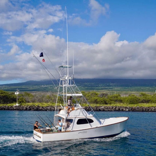 39ft Custom Sportsfisher Boat, the High Flier coasting along the calm waters off the coast of Kona Hawaii