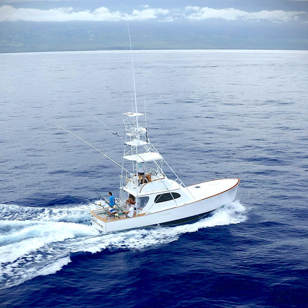 39ft Custom Sportsfisher Boat, the High Flier coasting along the calm waters off the coast of Kona Hawaii